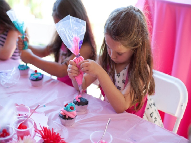 Kid decorating cupcake
